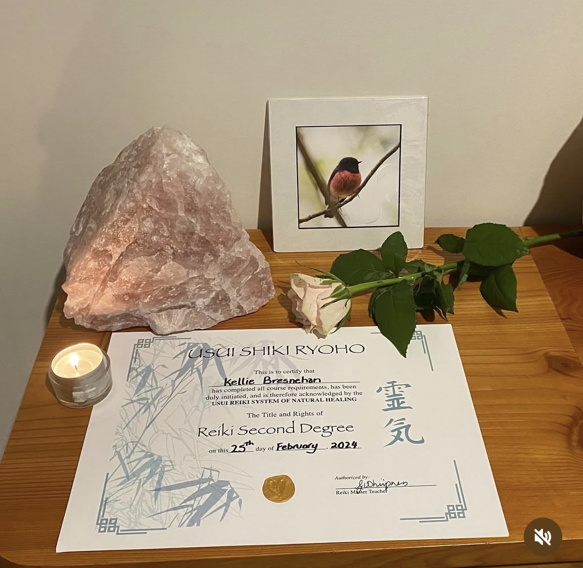 Reiki space with rose quartz crystal, candle and a single rose